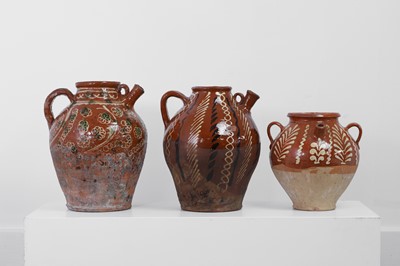 Lot 47 - Three terracotta slipware jugs