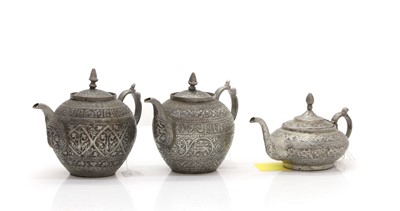 Lot 306 - A collection of three Afghan metalware teapots