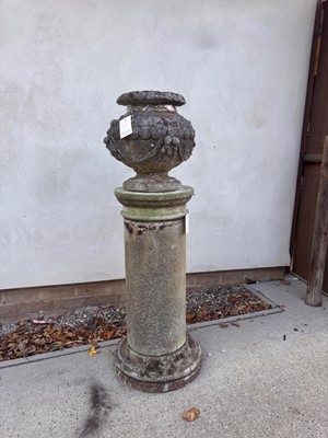 Lot 552 - A reconstituted stone garden urn on stand