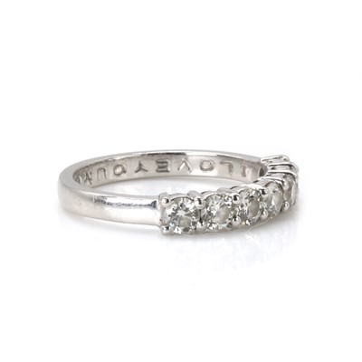 Lot 76 - A platinum and diamond half eternity ring
