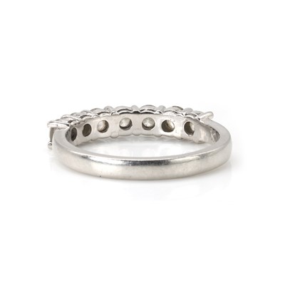 Lot 76 - A platinum and diamond half eternity ring