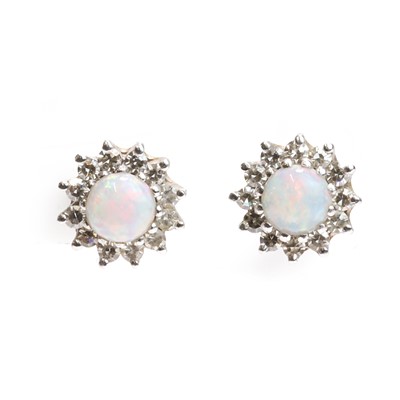 Lot 1108 - A pair of opal and diamond cluster earrings