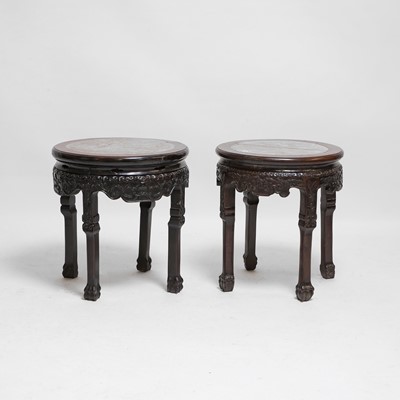 Lot 322 - A pair of low carved hardwood and marble-inset stands