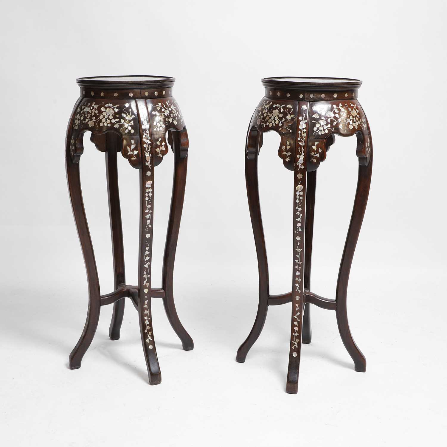 Lot 188 - A pair of Chinese carved wood and mother-of-pearl inlaid pedestal stands