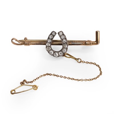 Lot 1016 - A diamond horseshoe bar brooch