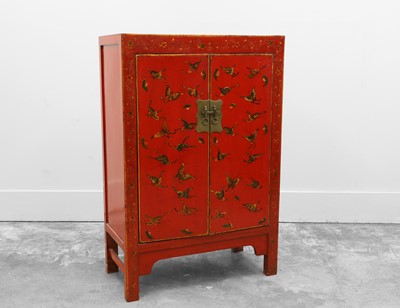 Lot 517 - A Chinese red lacquered and painted marriage cupboard