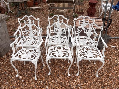 Lot 553 - A cast iron garden table and six chairs