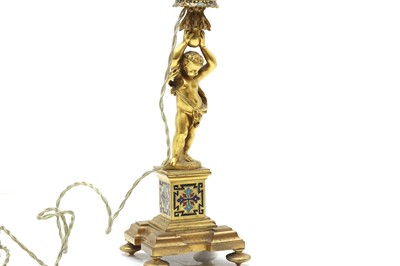 Lot 480 - A French ormolu and champlevé candlestick