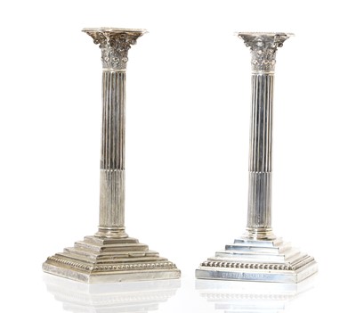 Lot 27 - A pair of silver-plated Corinthian silver candlesticks