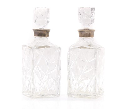 Lot 21 - A pair of silver mounted glass whisky decanters