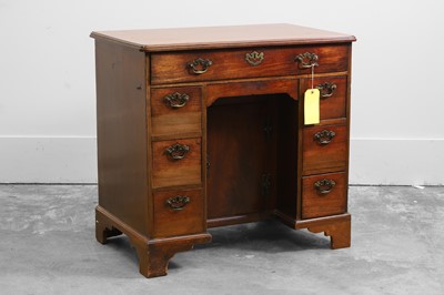 Lot 511 - A mahogany kneehole desk