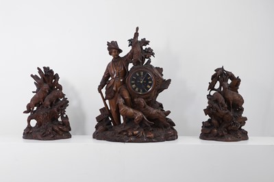 Lot 237 - A carved Black Forest clock garniture by Bergen & Co.