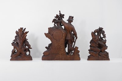 Lot 237 - A carved Black Forest clock garniture by Bergen & Co.