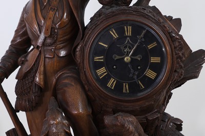 Lot 237 - A carved Black Forest clock garniture by Bergen & Co.