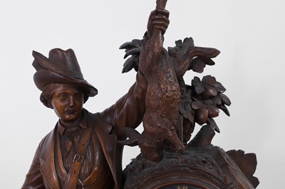 Lot 237 - A carved Black Forest clock garniture by Bergen & Co.