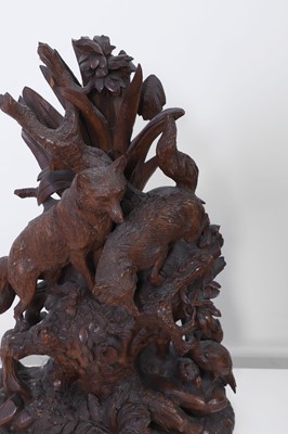 Lot 237 - A carved Black Forest clock garniture by Bergen & Co.