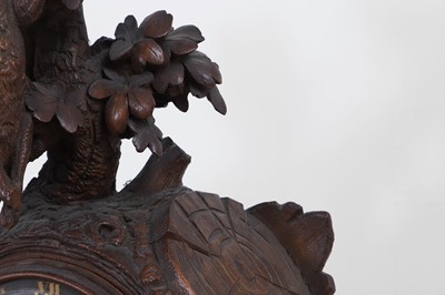 Lot 237 - A carved Black Forest clock garniture by Bergen & Co.