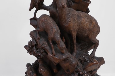 Lot 237 - A carved Black Forest clock garniture by Bergen & Co.