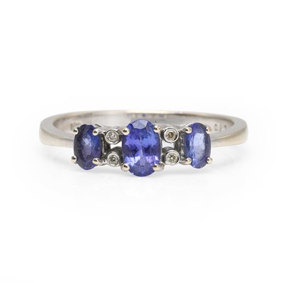 Lot 1090 - An 18ct white gold tanzanite three stone ring
