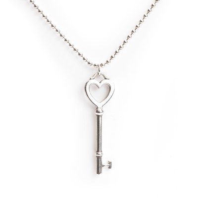 Lot 1115 - A silver heart shaped key pendant and chain, by Tiffany & Co.