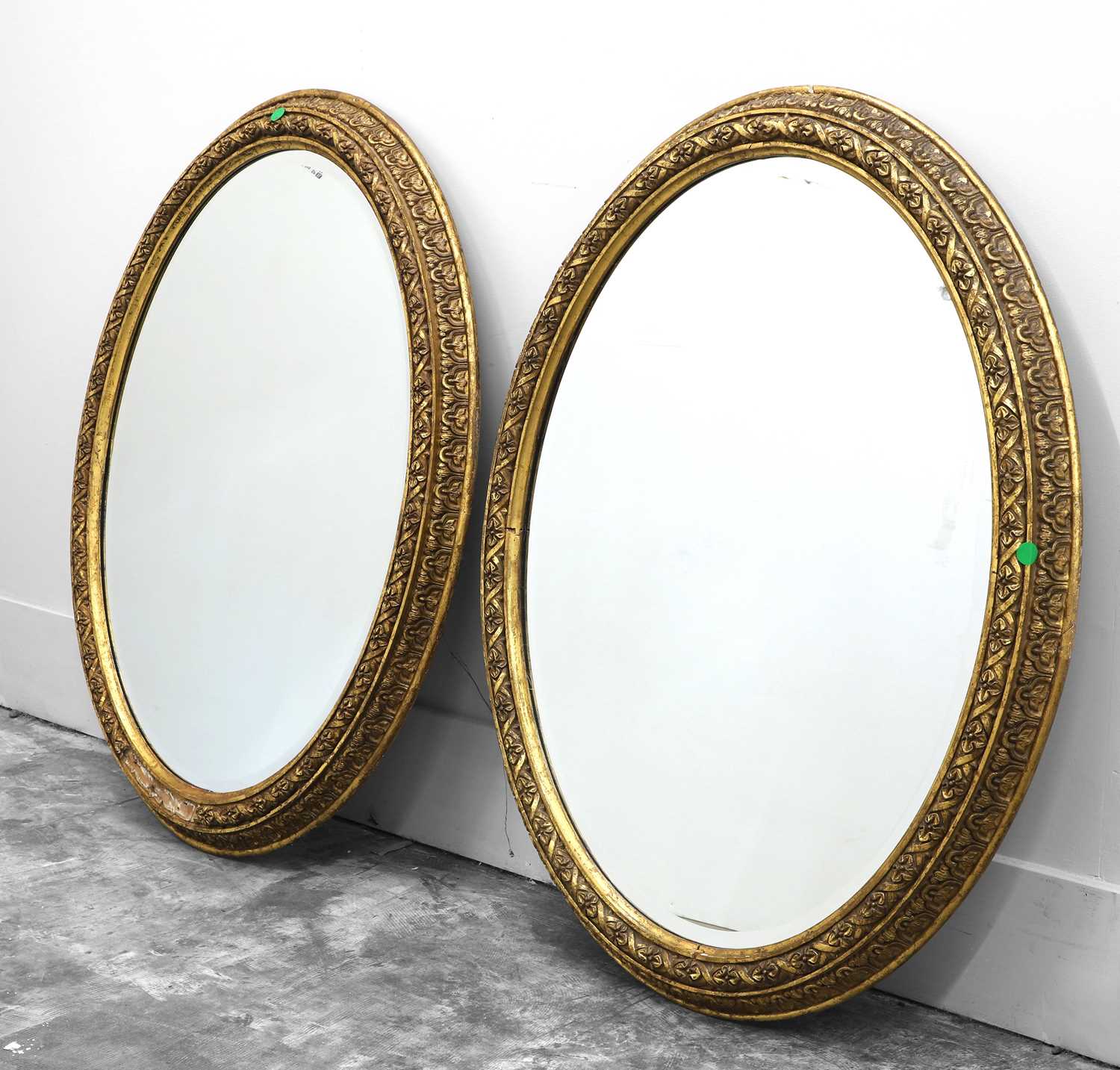 Lot 491 - A pair of gilt oval wall mirrors
