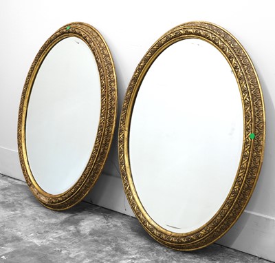Lot 491 - A pair of giltwood oval wall mirrors
