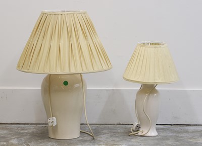 Lot 476 - A near pair of cream glazed porcelain lamps