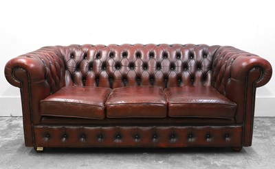 Lot 501 - A red leather Chesterfield three seater sofa