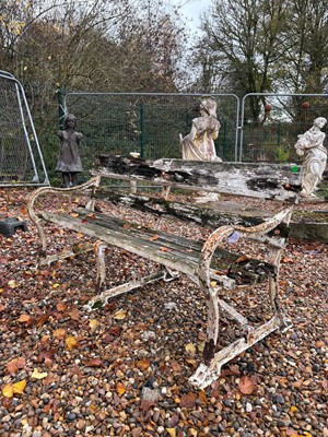 Lot 556 - A wrought iron and teak garden bench