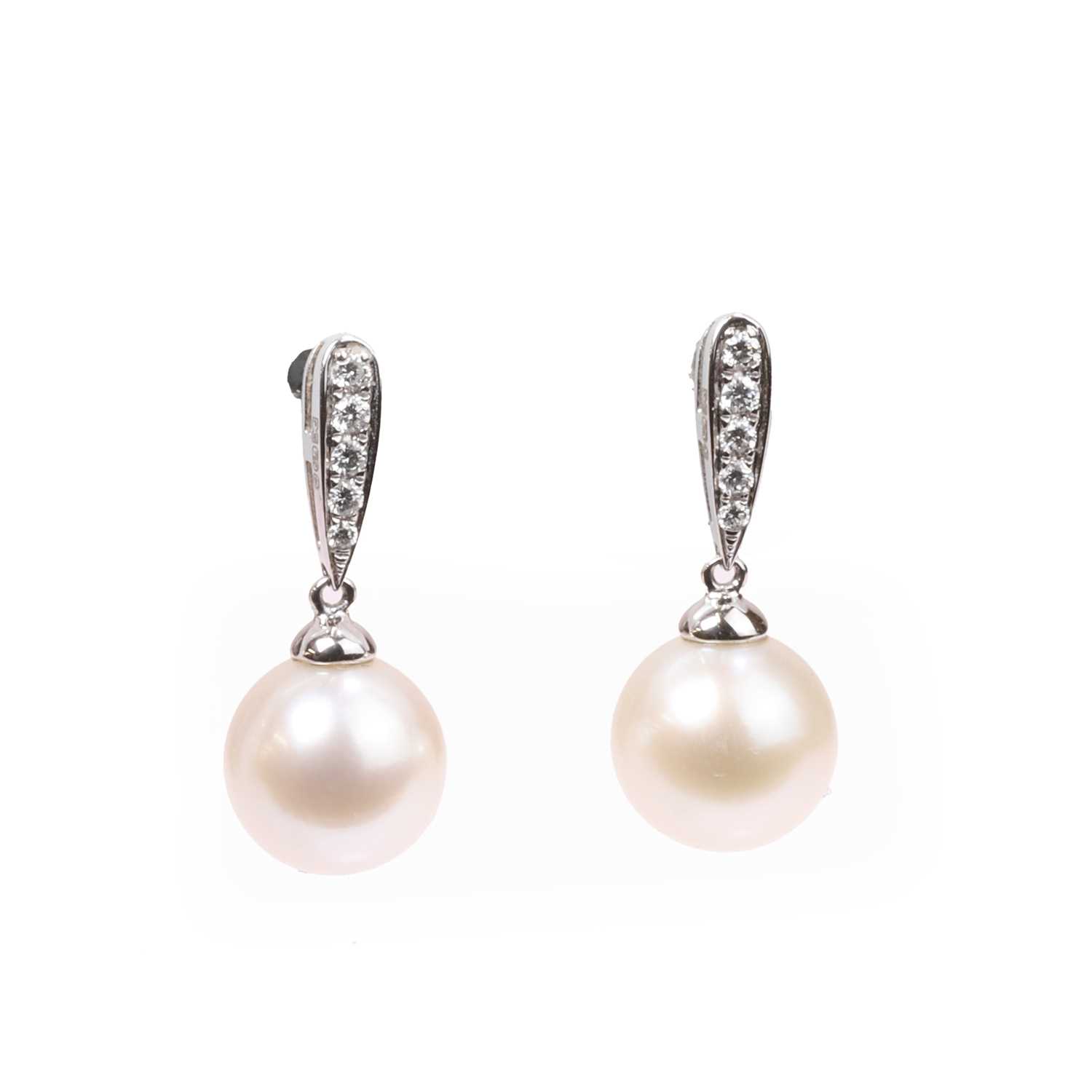 Lot 1133 - A pair of cultured pearl and diamond stud earrings
