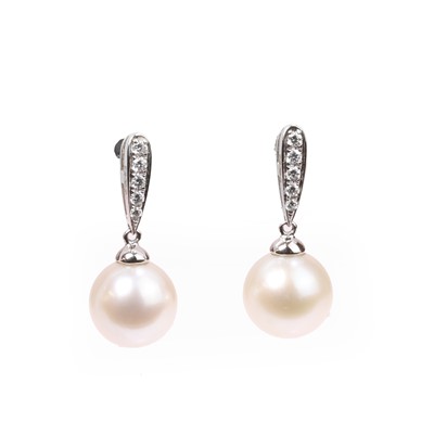Lot 1133 - A pair of cultured pearl and diamond stud earrings