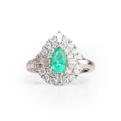 Lot 1082 - A platinum emerald and diamond cluster ring