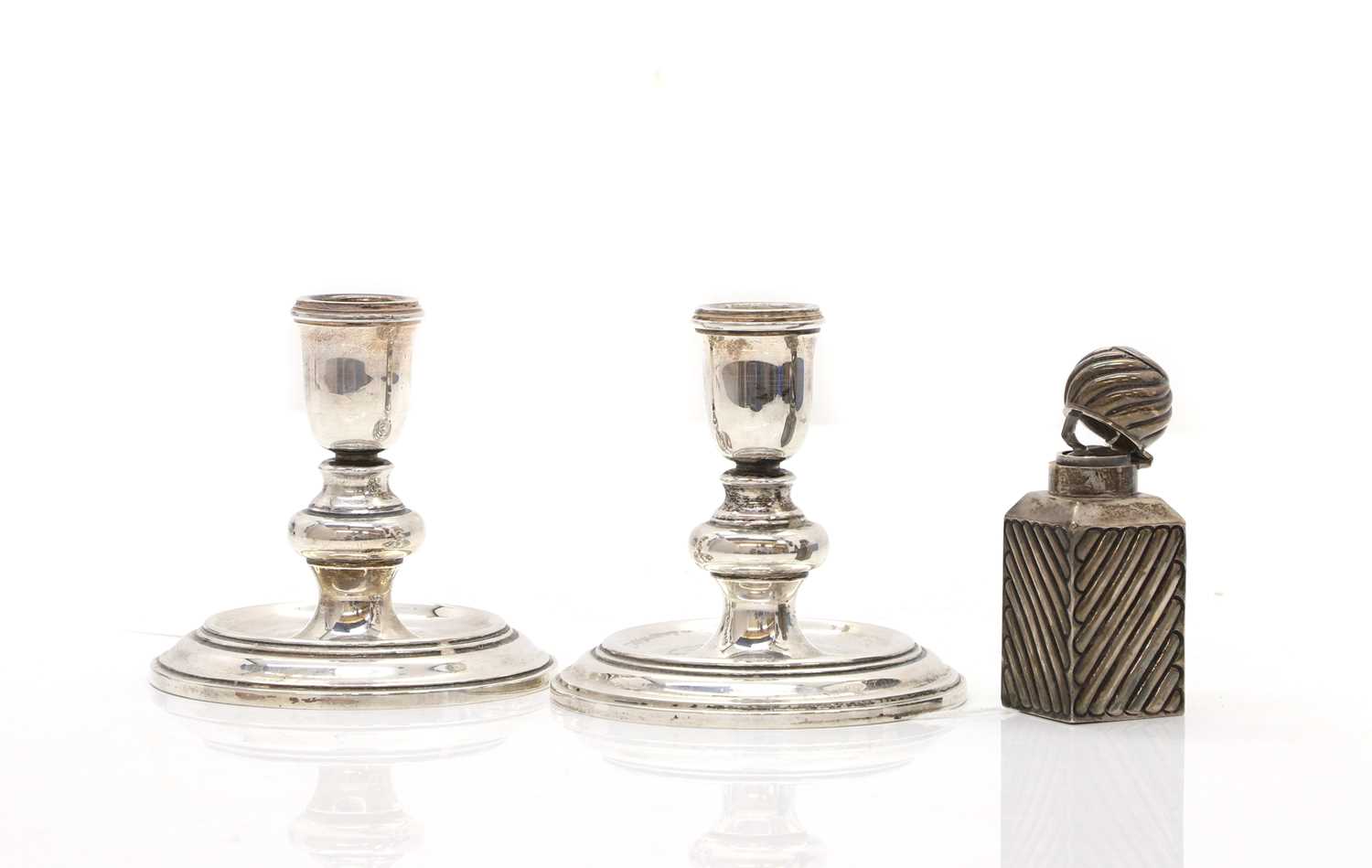 Lot 3 - A pair of dwarf silver candlesticks