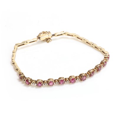 Lot 1056 - A 14ct gold ruby and diamond line bracelet