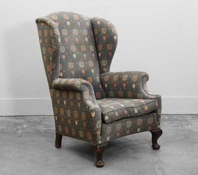 Lot 516 - A Queen Ann style wing armchair