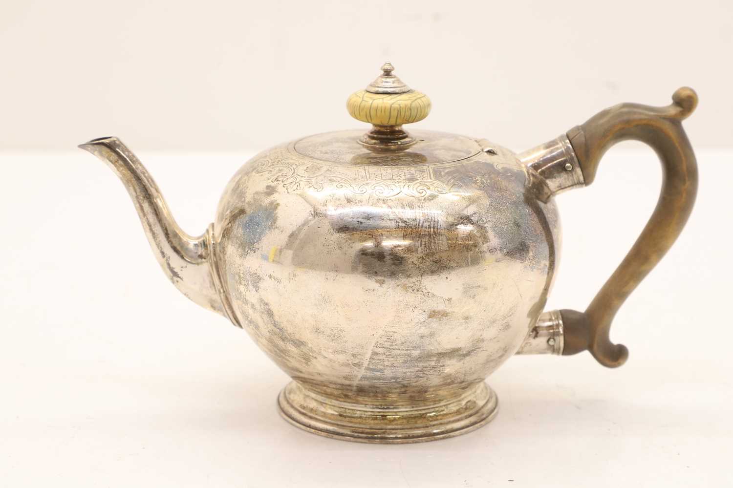 Lot 19 - A George II silver bullet form teapot