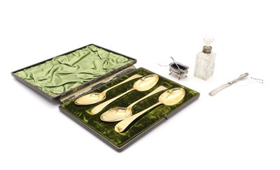 Lot 21 - A cased set of four silver gilt serving spoons