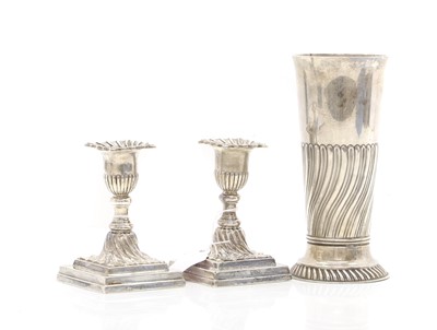 Lot 23 - A pair of silver dwarf candlesticks