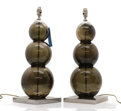 Lot 475 - A pair of amethyst glass table lamps