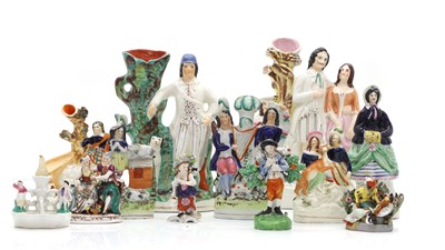 Lot 105 - A collection of Staffordshire pottery figures and flatbacks