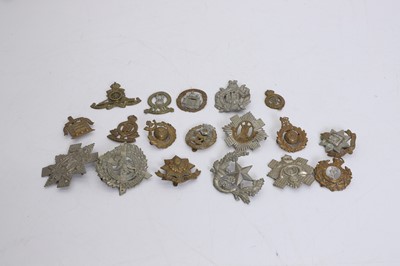 Lot 367 - A collection of brass and metal cap badges
