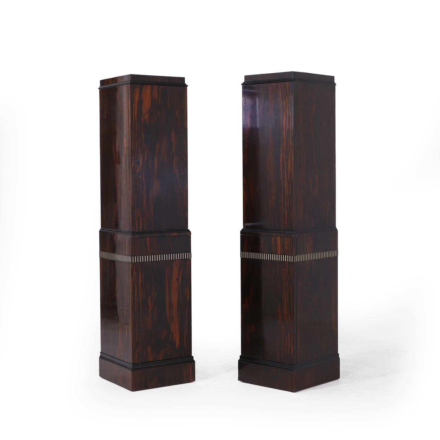 Lot 46 - A pair of Art Deco coromandel, ebonised and ivory-inlaid pedestal cupboards