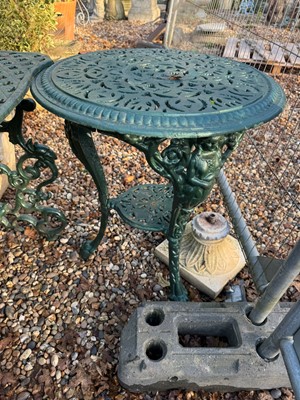 Lot 541 - A cast iron table and a pair of chairs