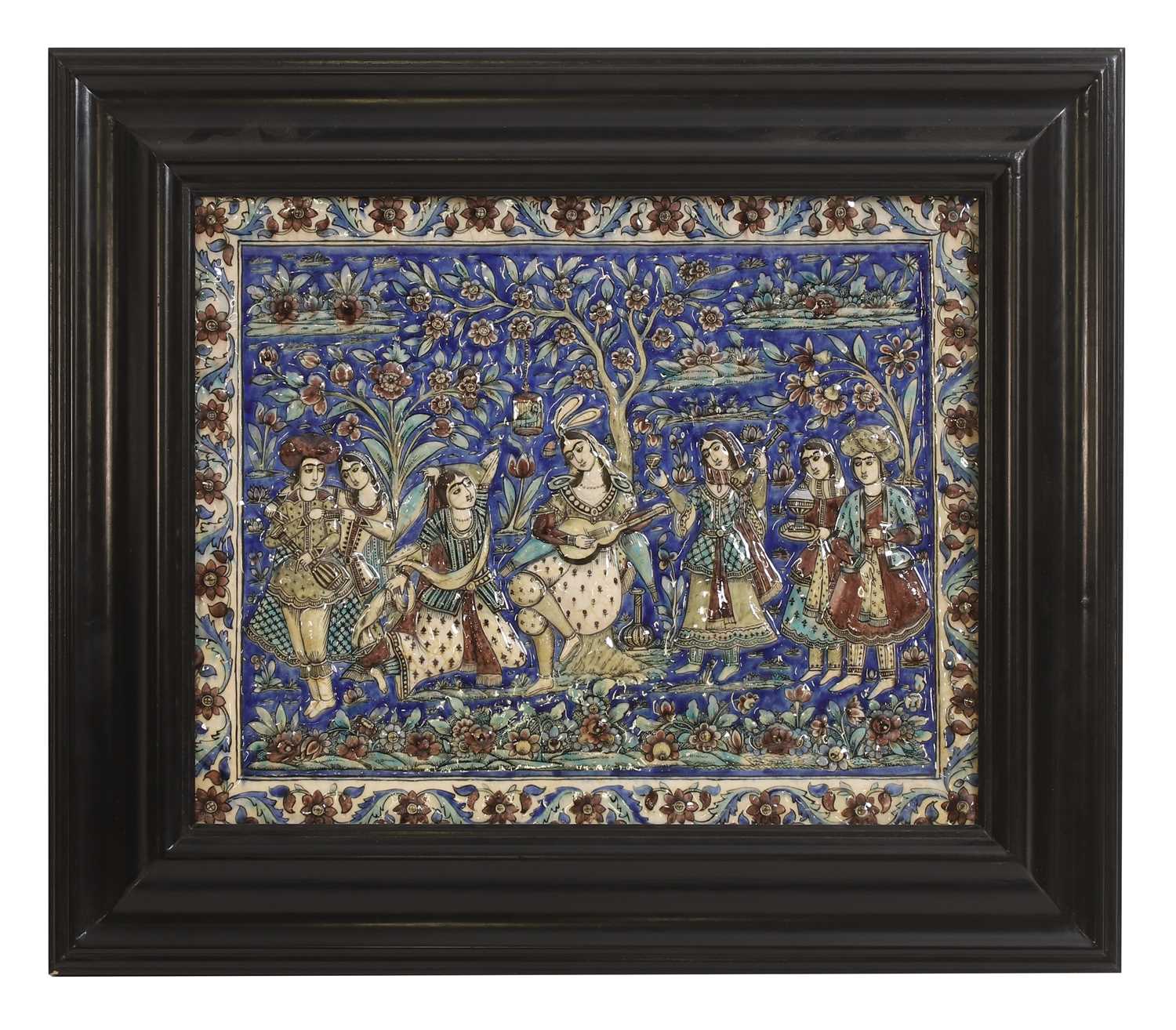 Lot 15 - A large Qajar moulded and underglaze-painted pottery figural tile