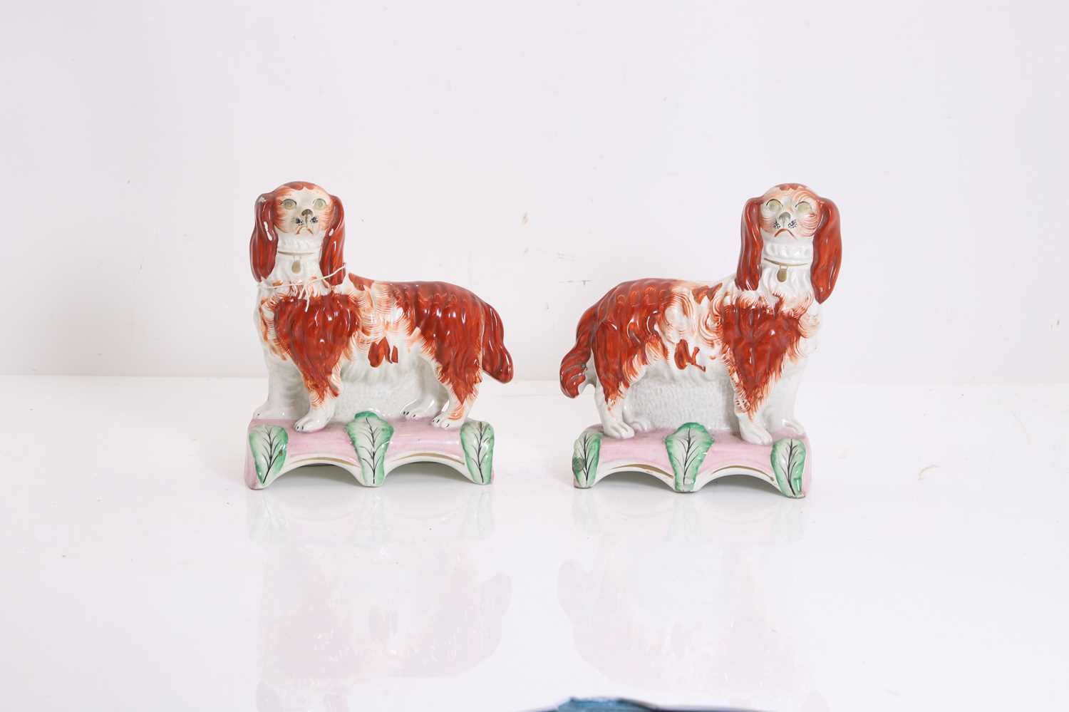 Lot 114 - A pair of Staffordshire pottery spaniels