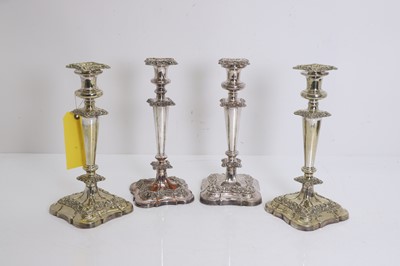 Lot 2 - A harequin set of four silver plated candlesticks