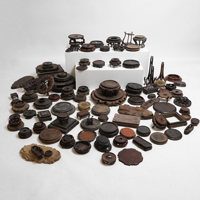 Lot 272 - A collection of 108 assorted Chinese and Japanese carved hardwood vase stands