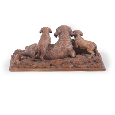 Lot 79 - A Black Forest carved linden wood figural dog group