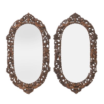 Lot 232 - A pair of carved walnut mirrors