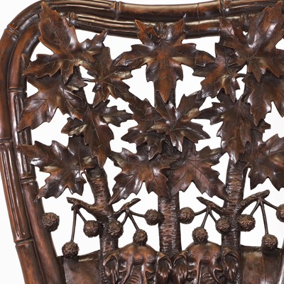 Lot 41 - A pair of carved linden wood Black Forest elbow chairs